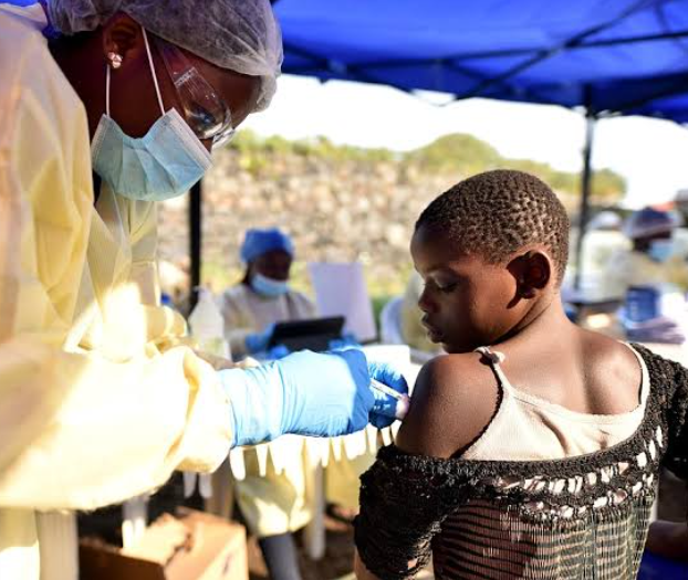 Health worker vaccinating a child